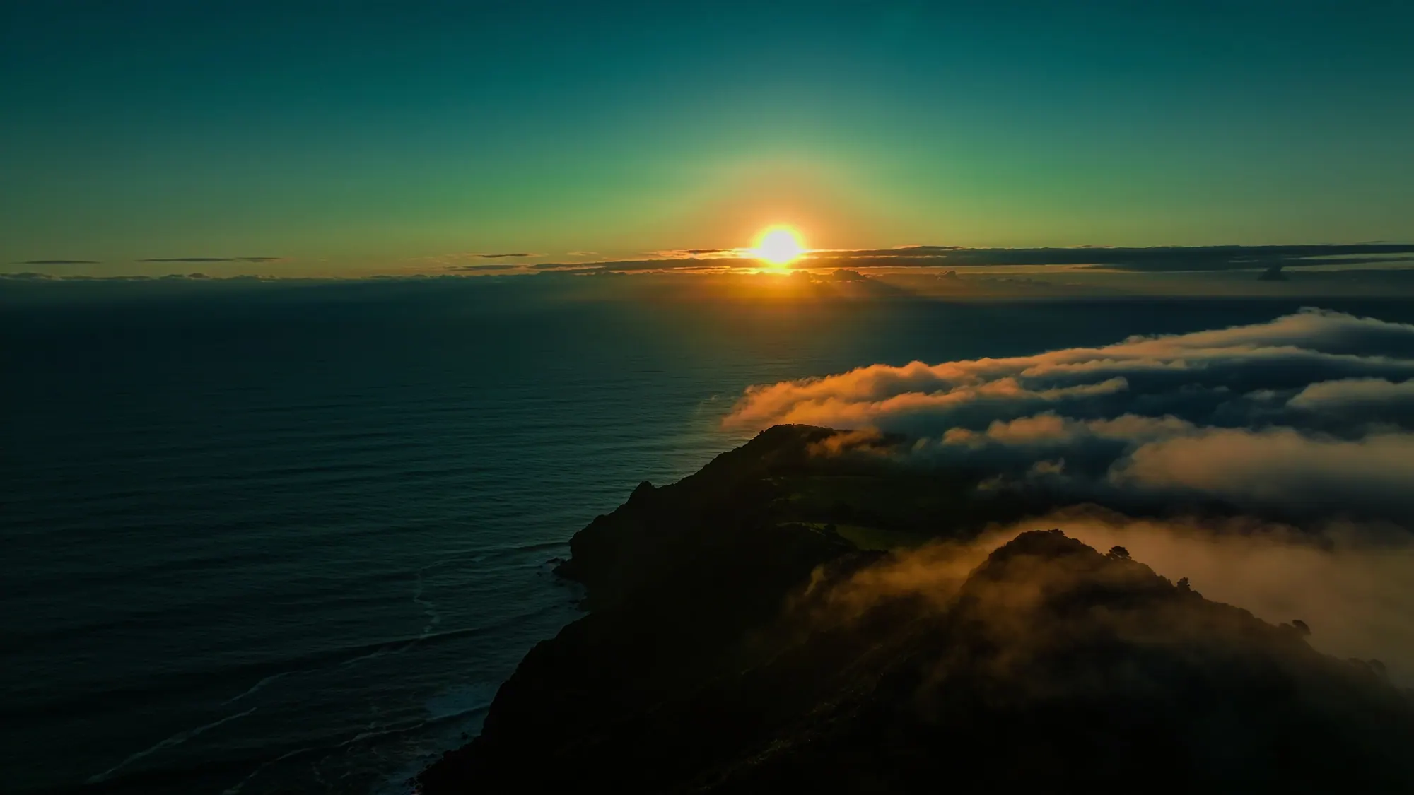 Sunrise over the ocean from a New Zealand clifftop headland